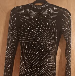 Small, see-through black dress with rhinestones and pearls.